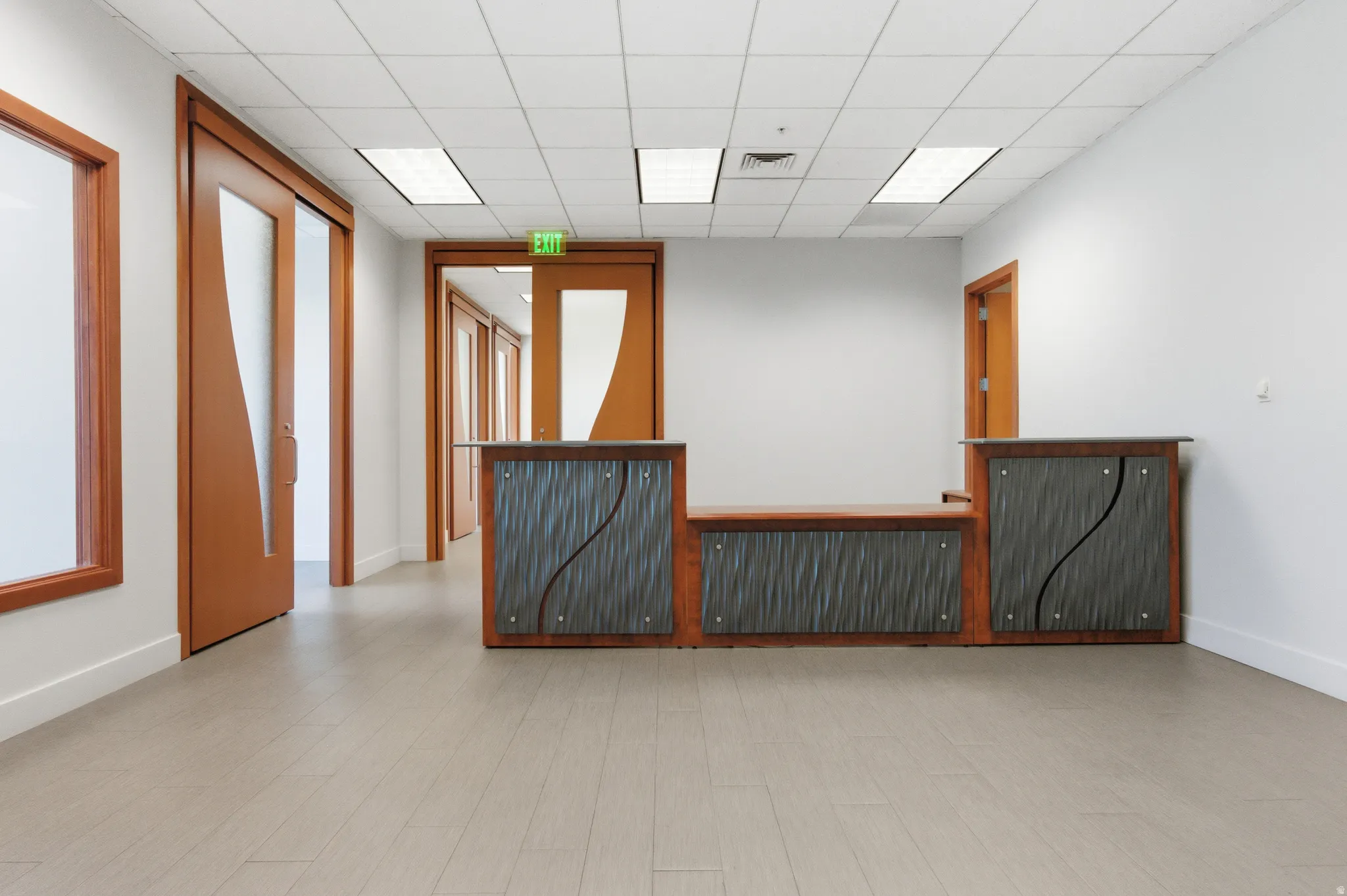 Empty room featuring radiator and a drop ceiling