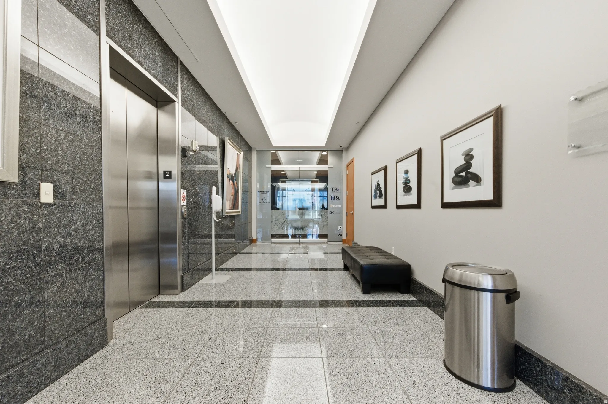 Hall with granite tiled floors and elevator