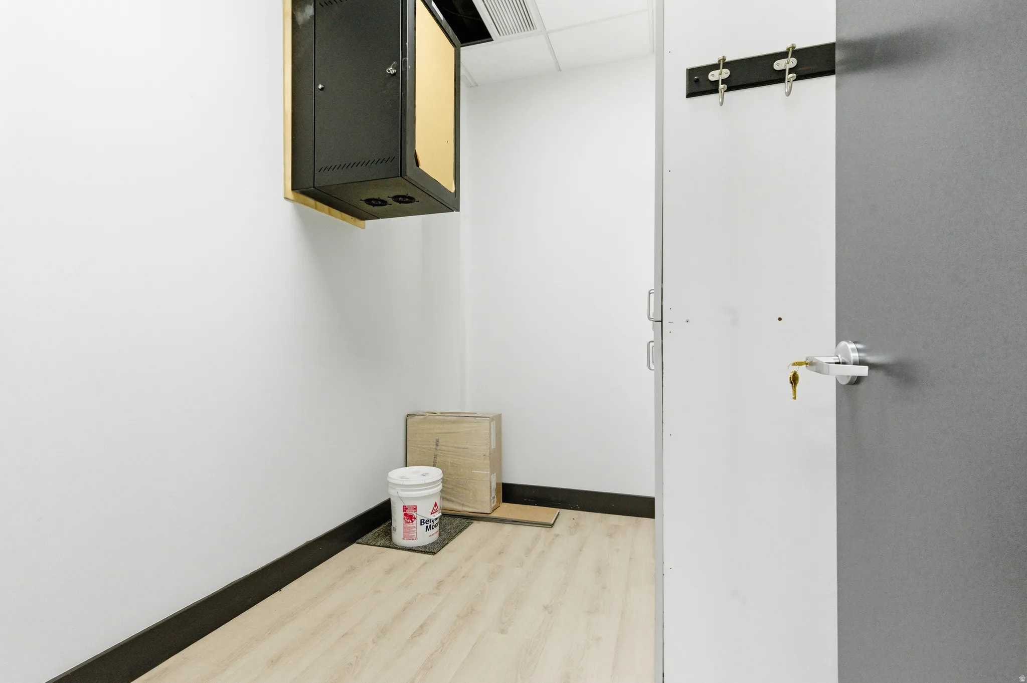Hall with baseboards and light wood-style flooring