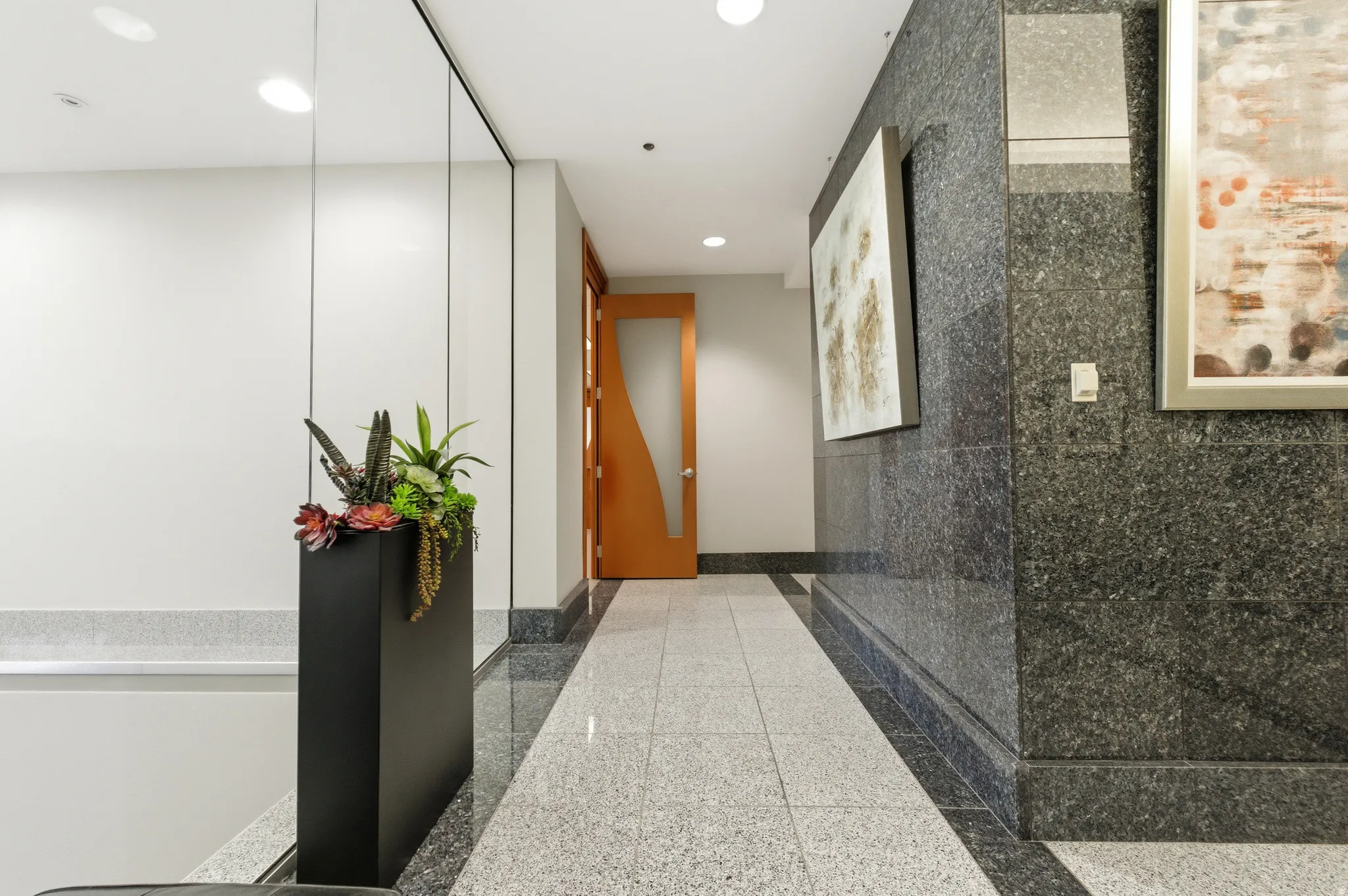 Hallway with recessed lighting and baseboards