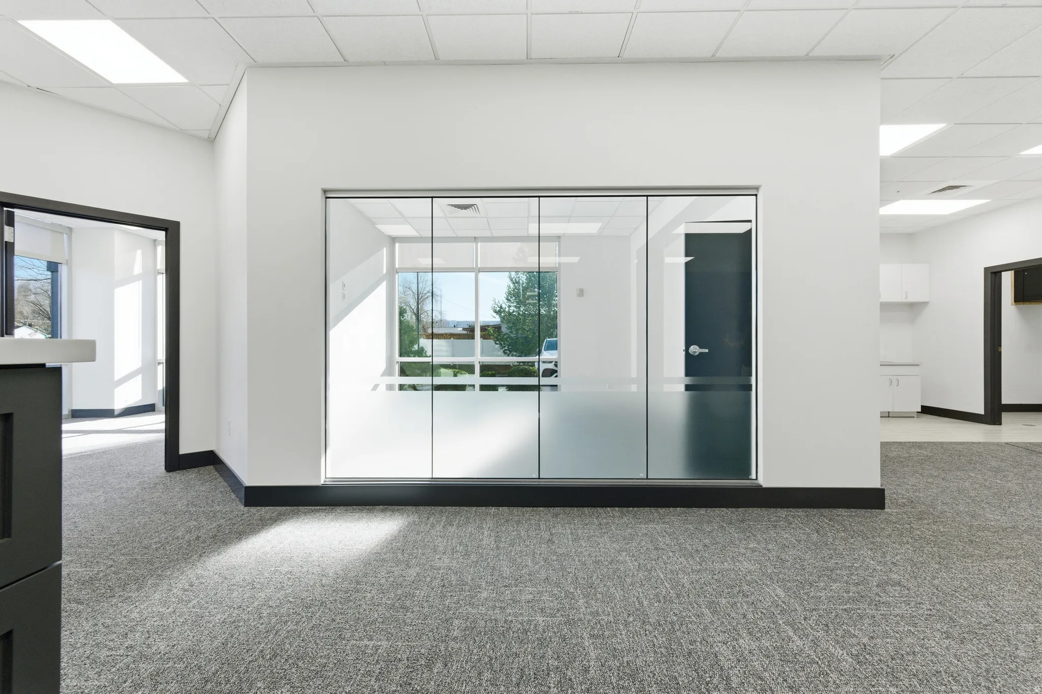 Unfurnished room featuring light colored carpet and a paneled ceiling