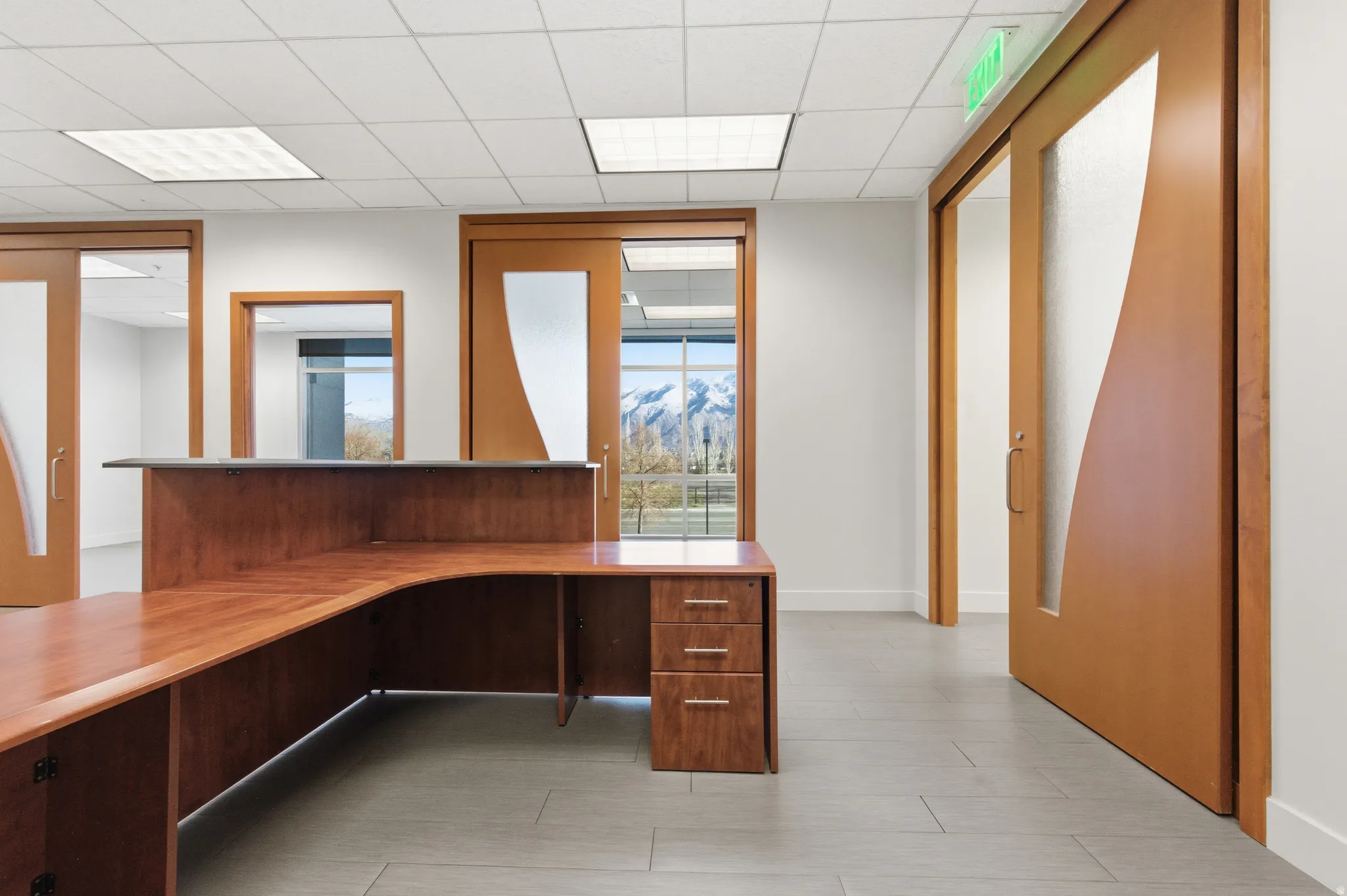 Unfurnished office featuring a paneled ceiling and a mountain view