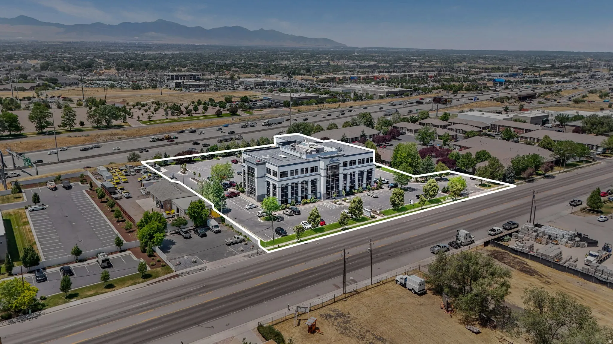 Aerial overview of property's location with a mountain backdrop and property parcel outlined