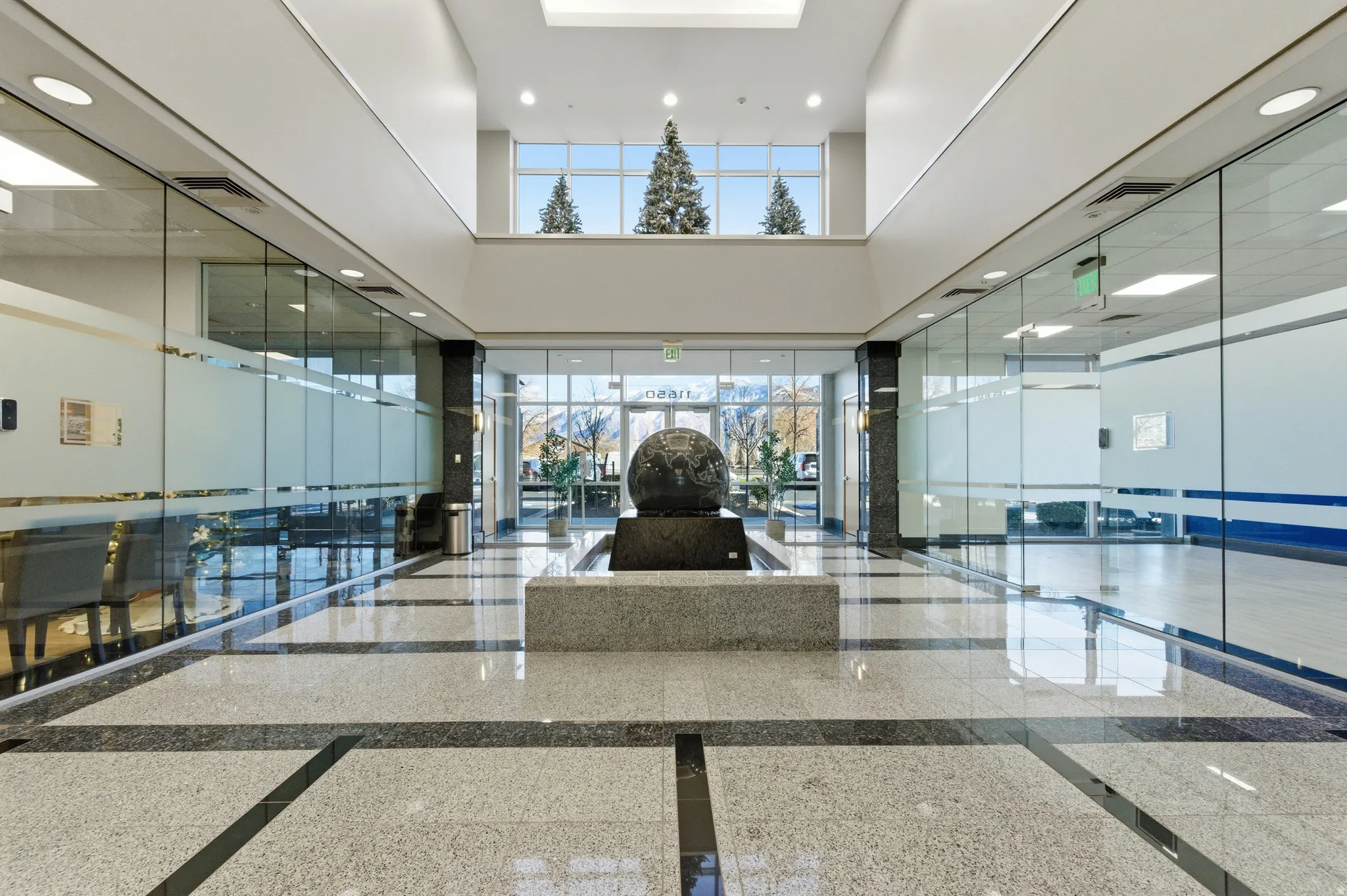 Building lobby featuring a towering ceiling and recessed lighting