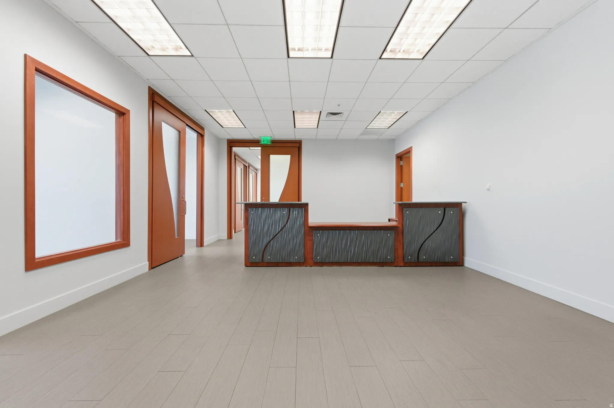 Spare room with radiator heating unit, a paneled ceiling, and wood finished floors