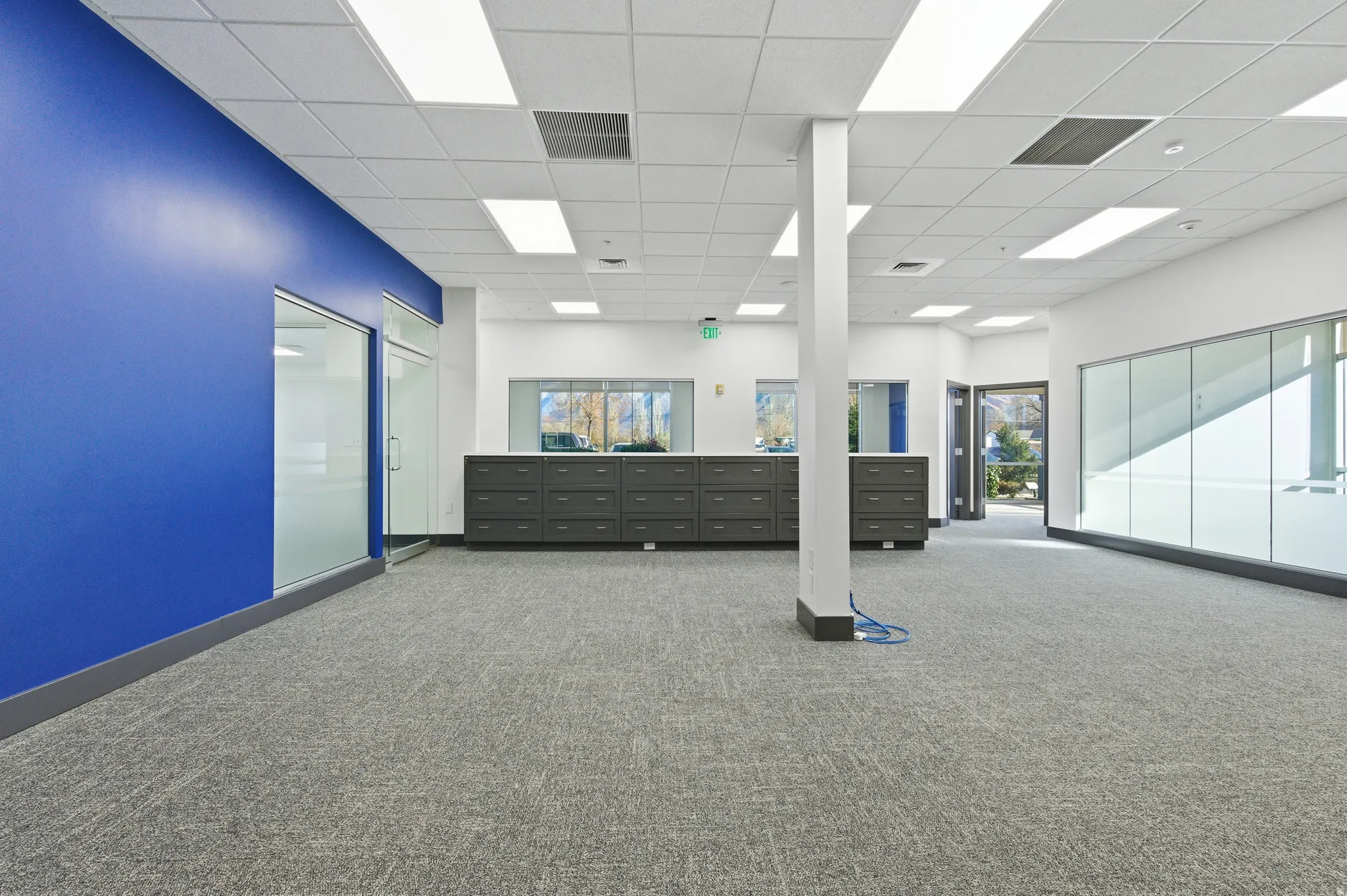 Carpeted spare room with baseboards and a paneled ceiling