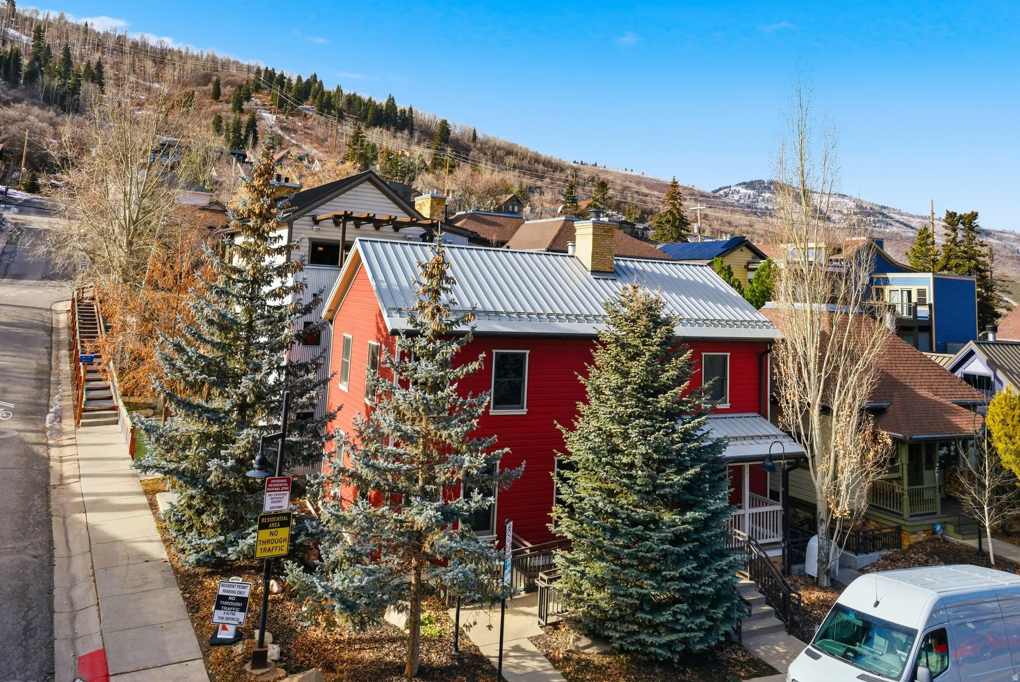 View of front of property featuring a mountain view, a chimney, and a standing seam roof