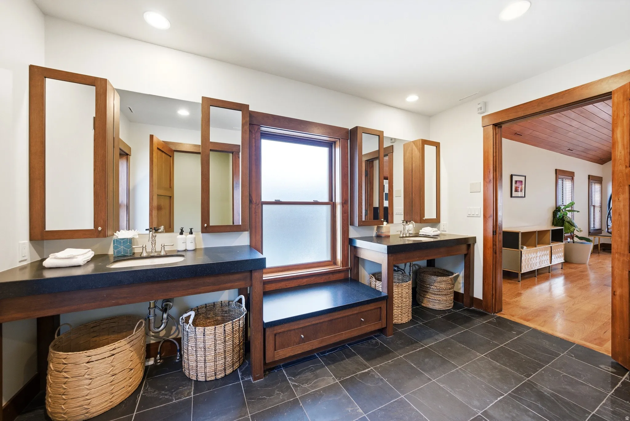 Bathroom with vanity and dark tile patterned flooring