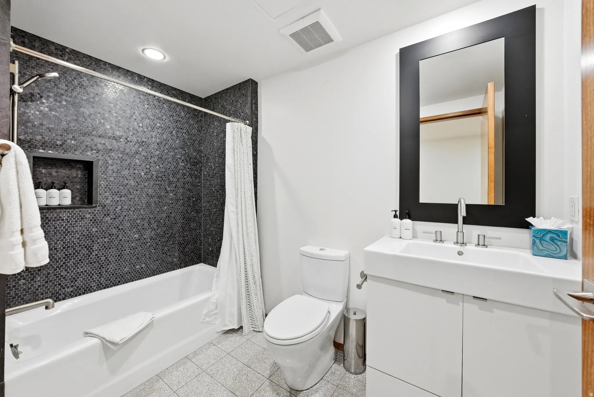 Full bath featuring vanity, shower / bath combo, and recessed lighting
