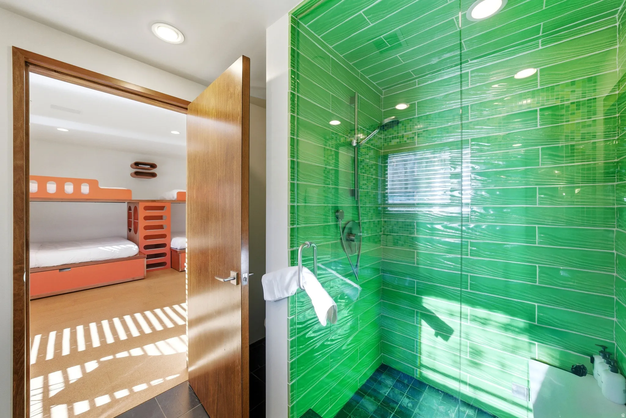 Ensuite bathroom with tiled shower and recessed lighting