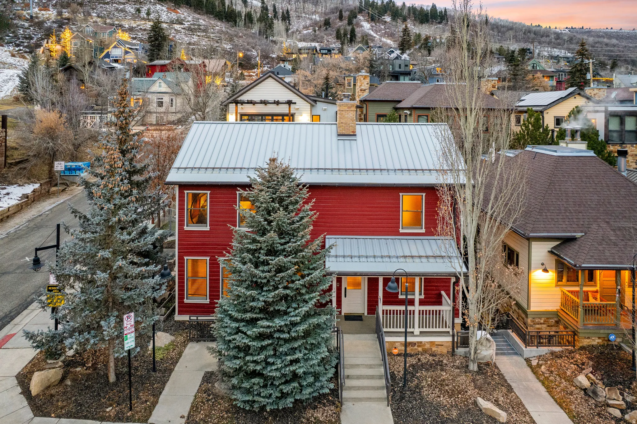 View of front facade featuring a standing seam roof, covered porch, and a residential view