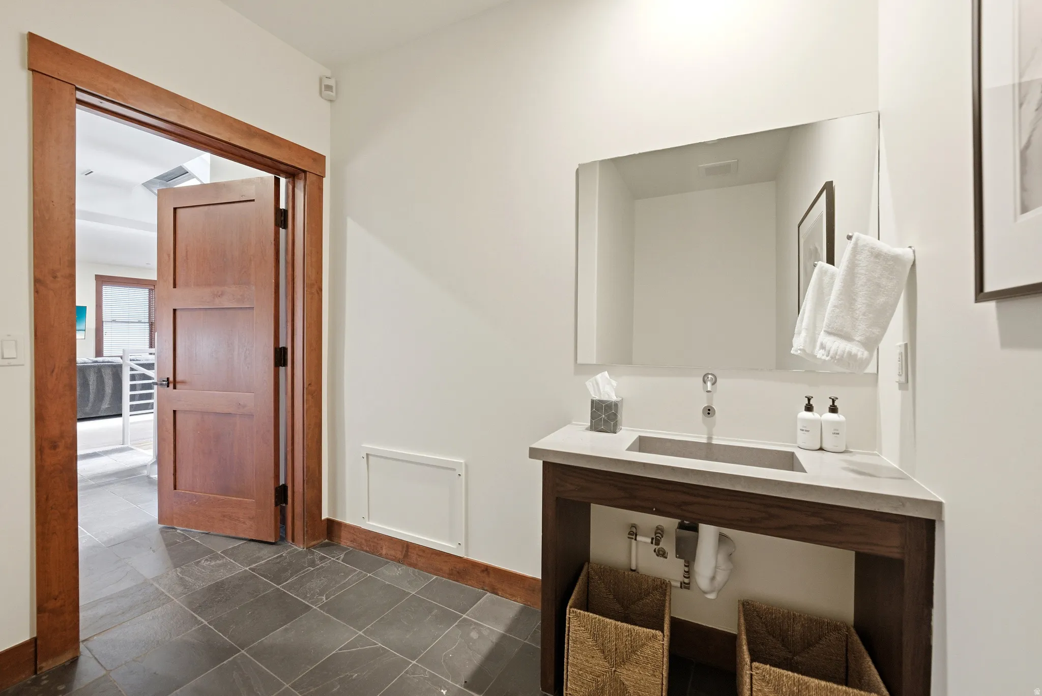 Bathroom featuring vanity and dark tile patterned flooring
