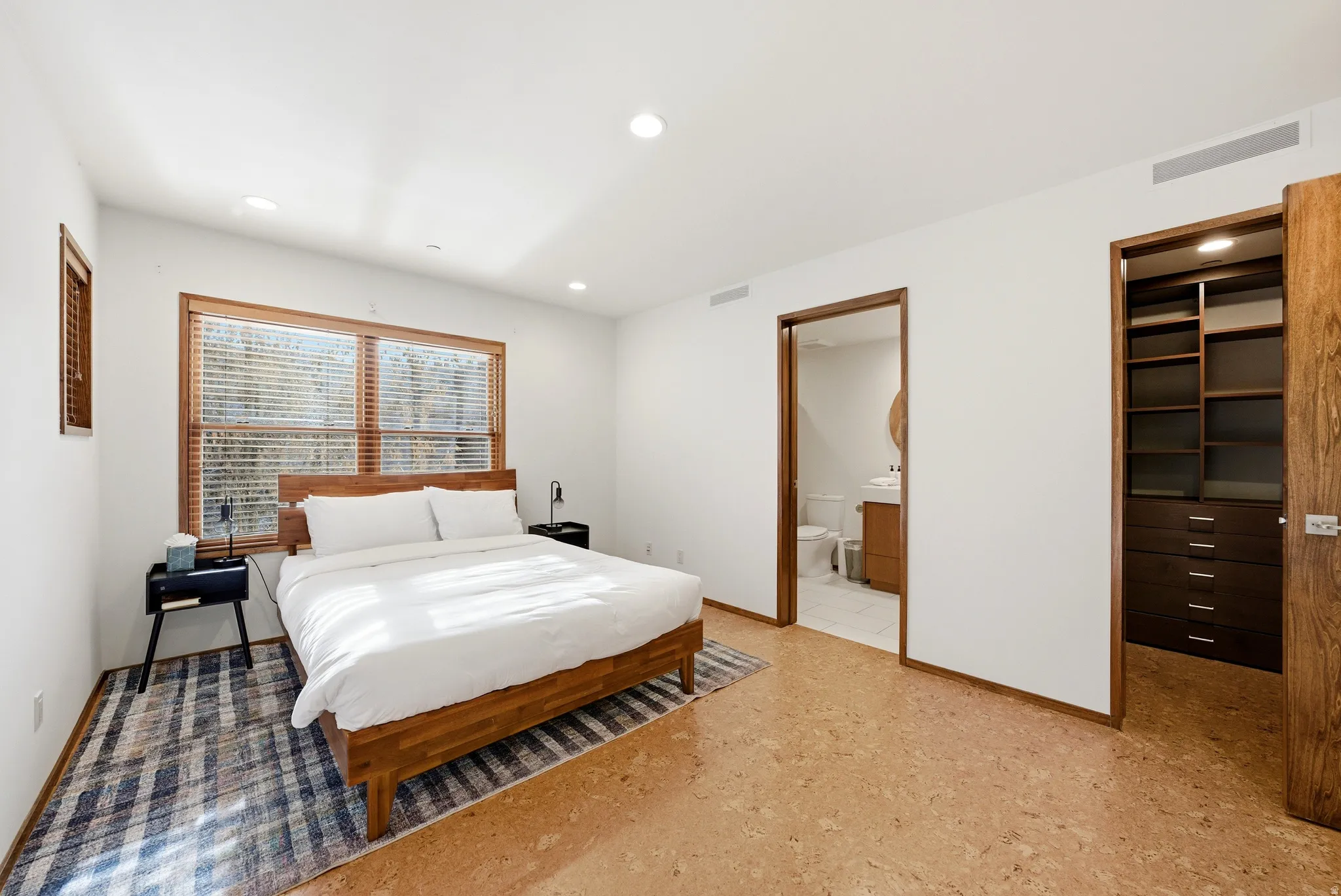 Bedroom with a spacious closet and recessed lighting