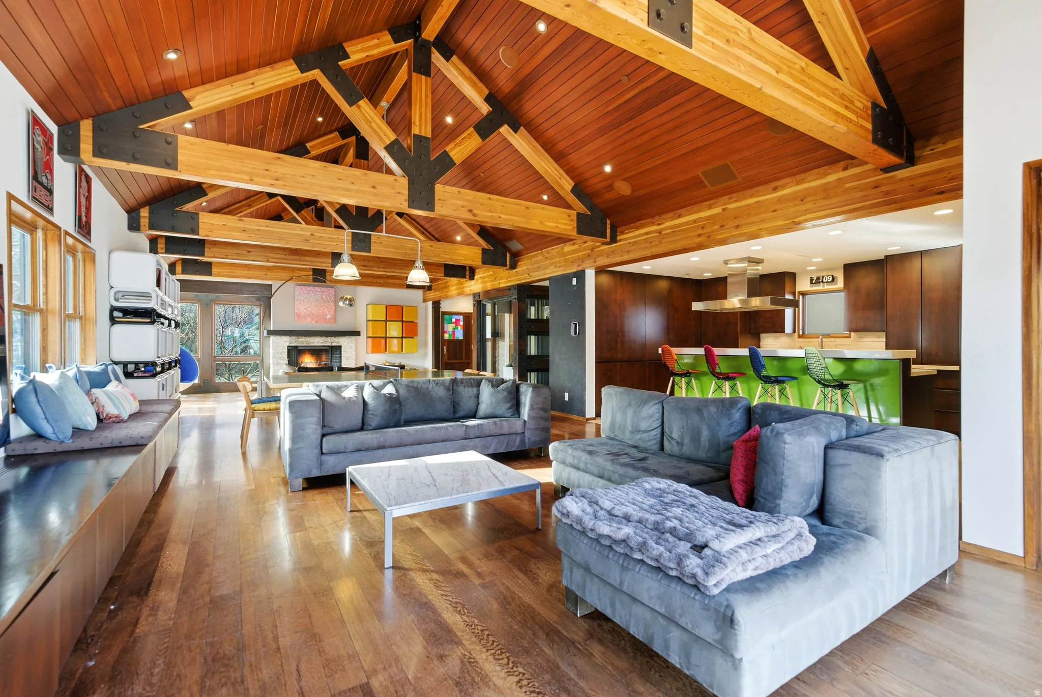 Living area with a high wooden beamed ceiling, hardwood / wood-style flooring, a fireplace, and recessed lighting