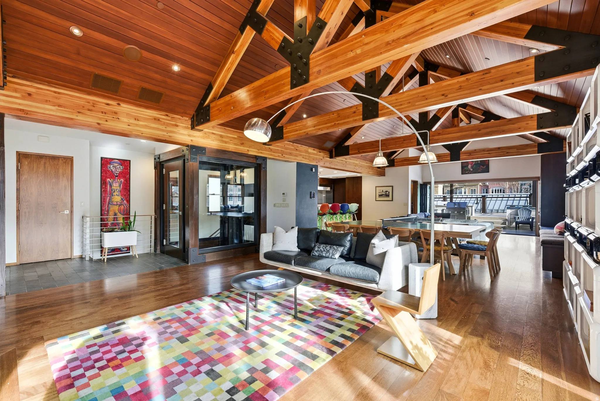 Living room with a high wood beamed ceiling and hardwood / wood-style floors