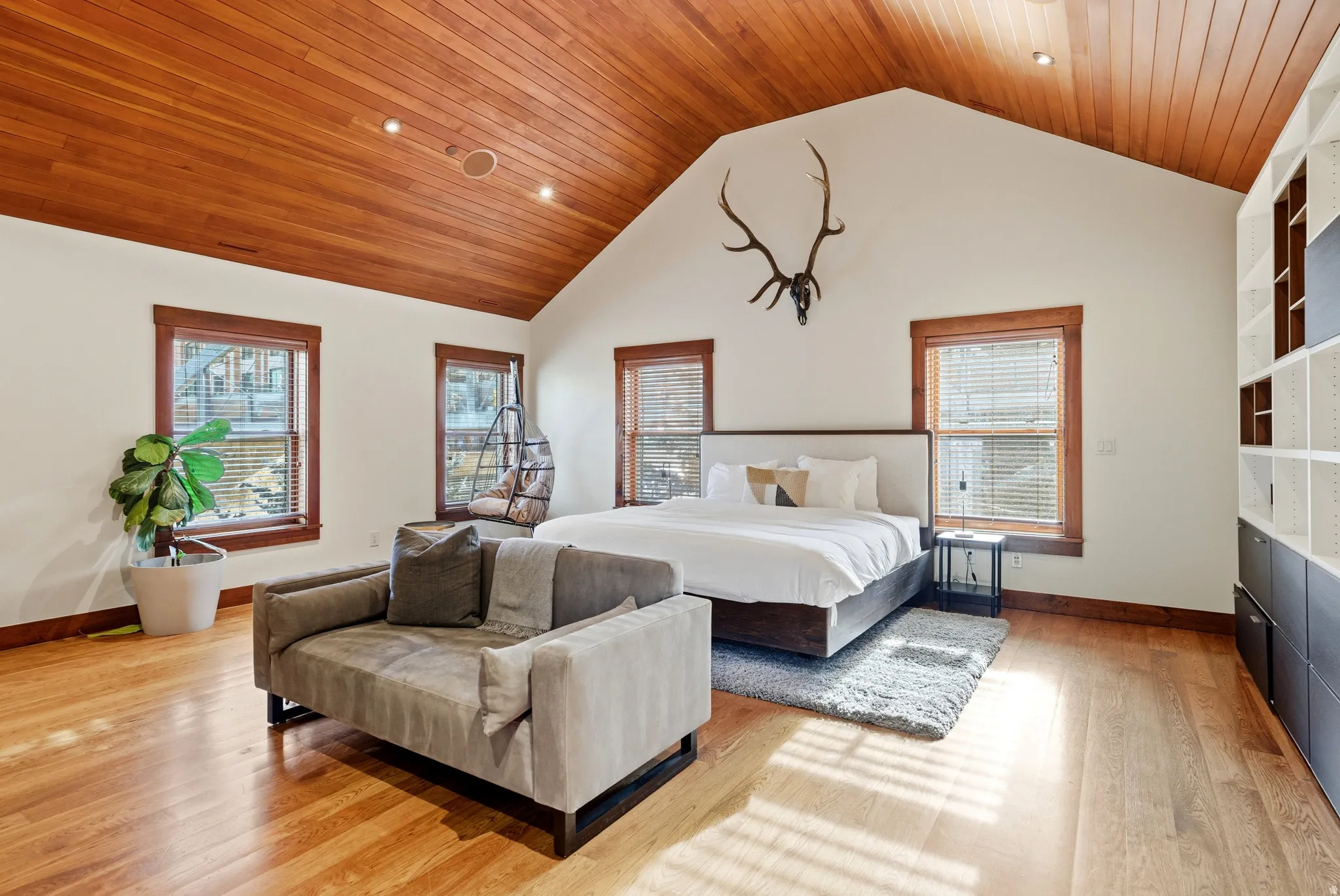 Bedroom with recessed lighting, a high wooden ceiling, and light wood finished floors