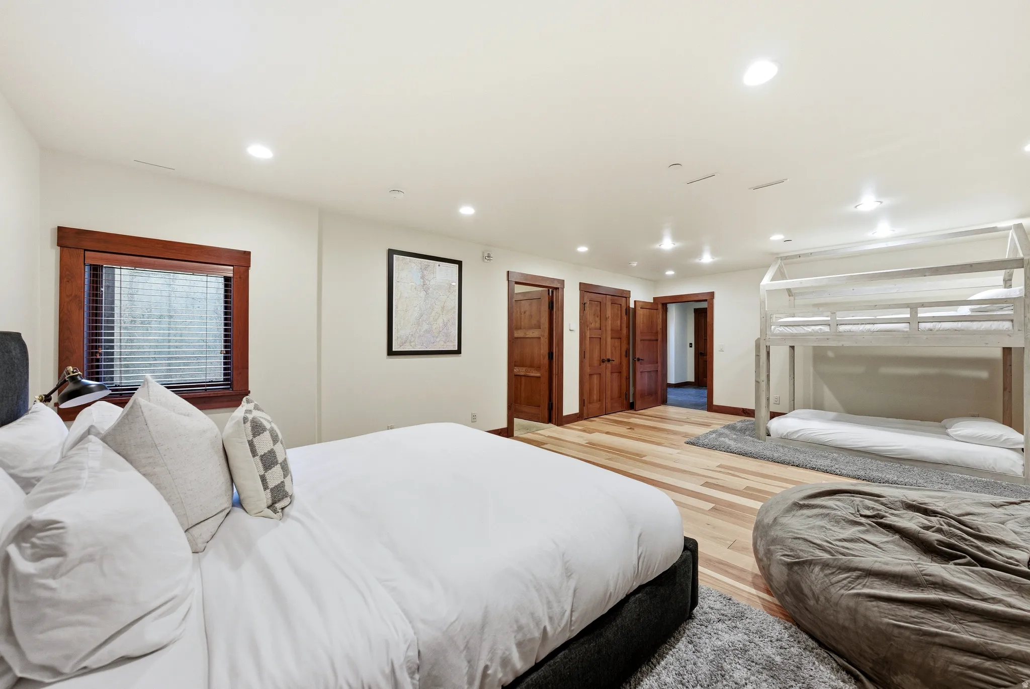 Bedroom with light wood finished floors and recessed lighting