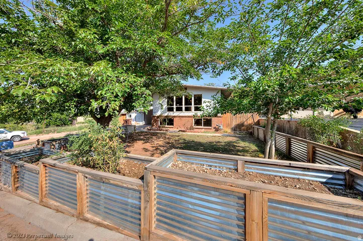 View of front of property featuring raised garden beds.