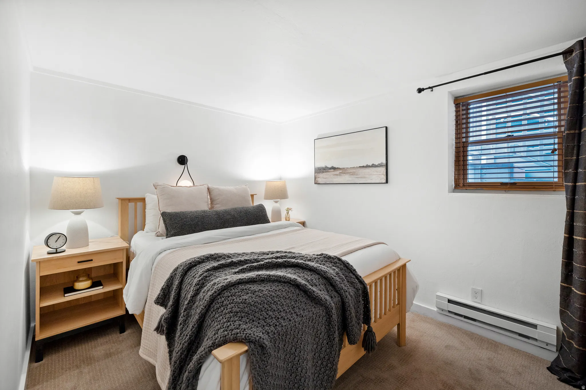Bedroom with baseboard heating and carpet