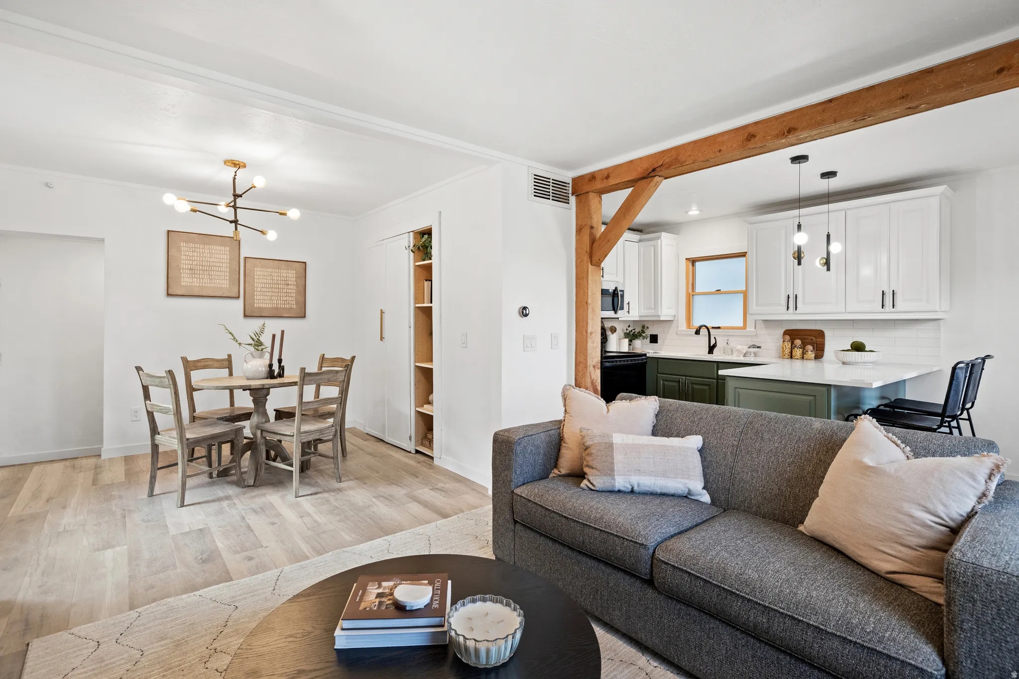 Living area featuring a chandelier and light wood-style floors