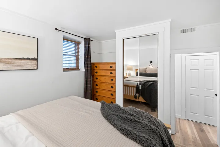 Bedroom featuring wood finished floors and a closet