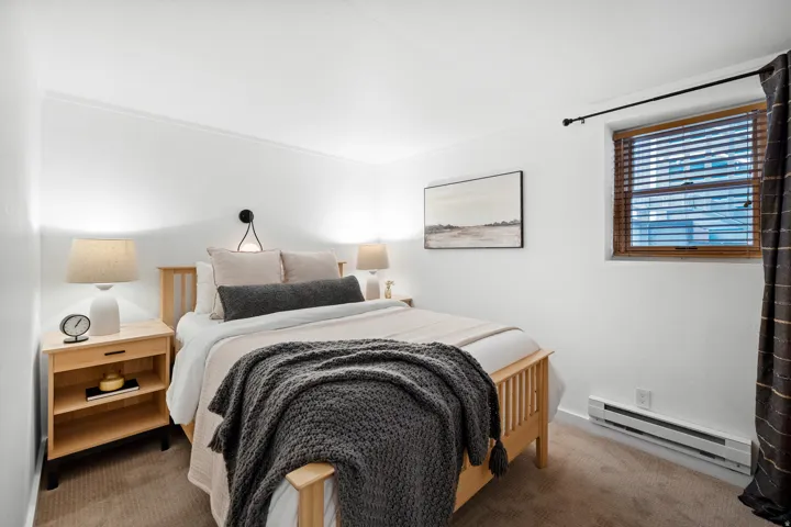 Bedroom with baseboard heating and carpet