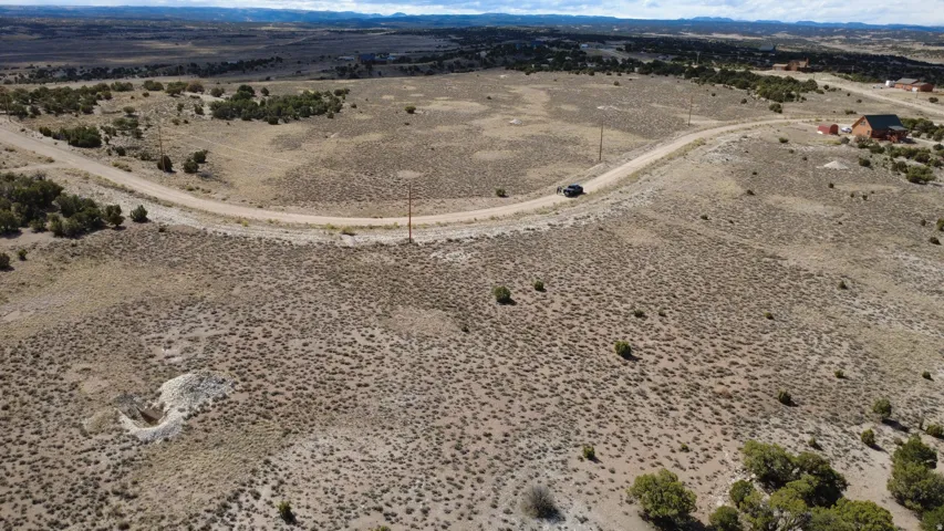 Aerial view of sparsely populated area featuring a desert landscape and a mountain backdrop