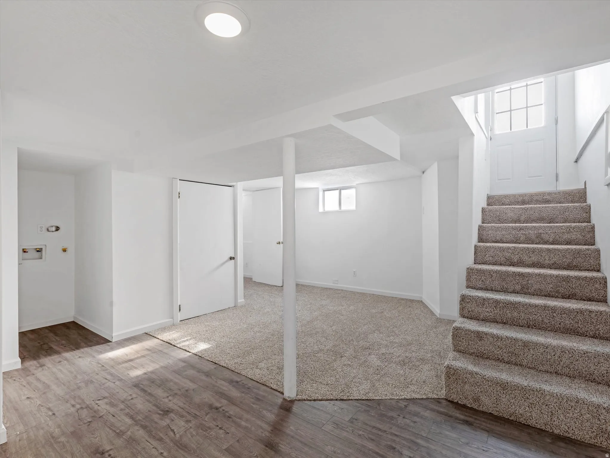 Below grade area featuring stairs and wood finished floors