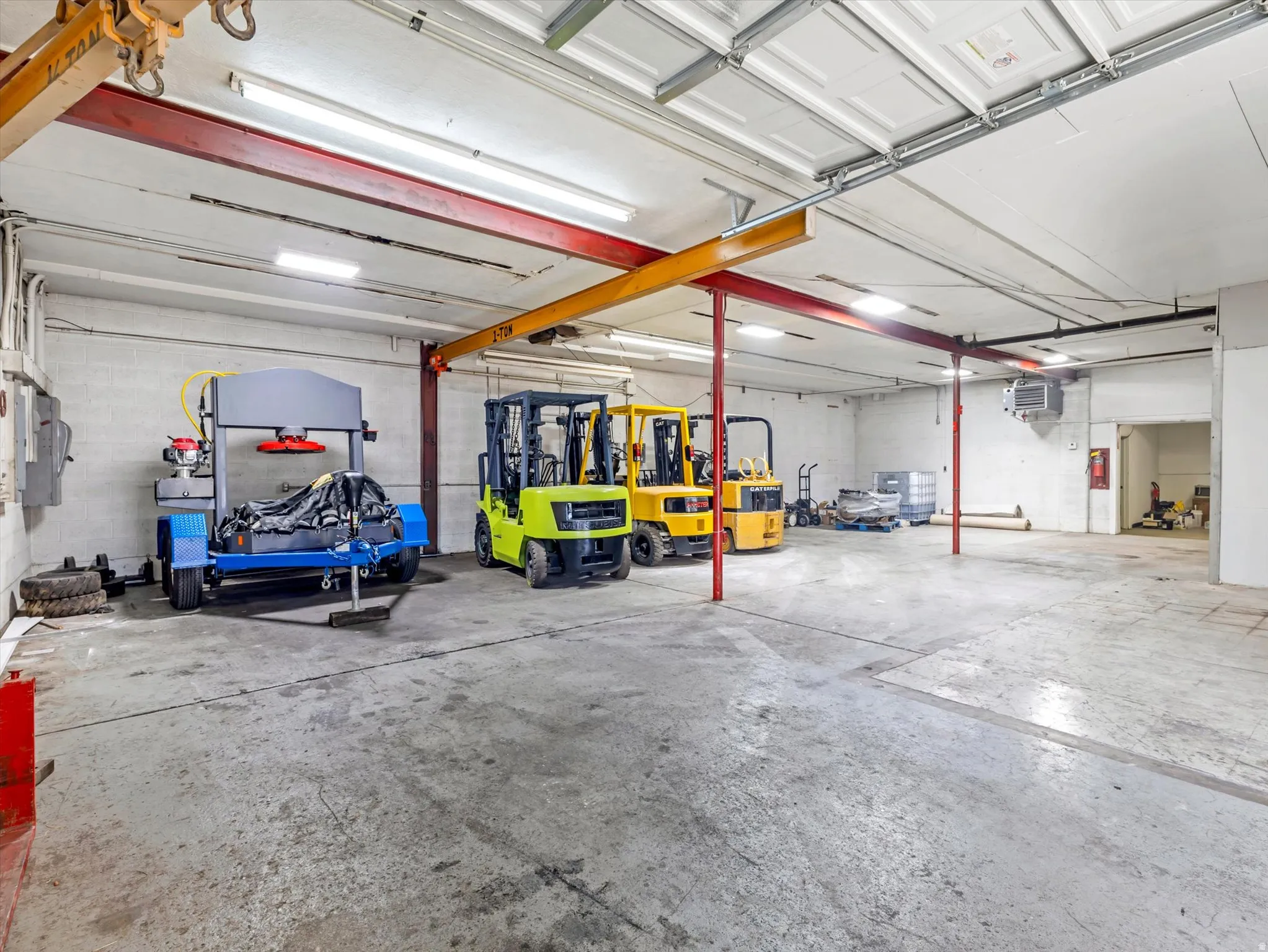 Garage featuring electric panel and a heating unit
