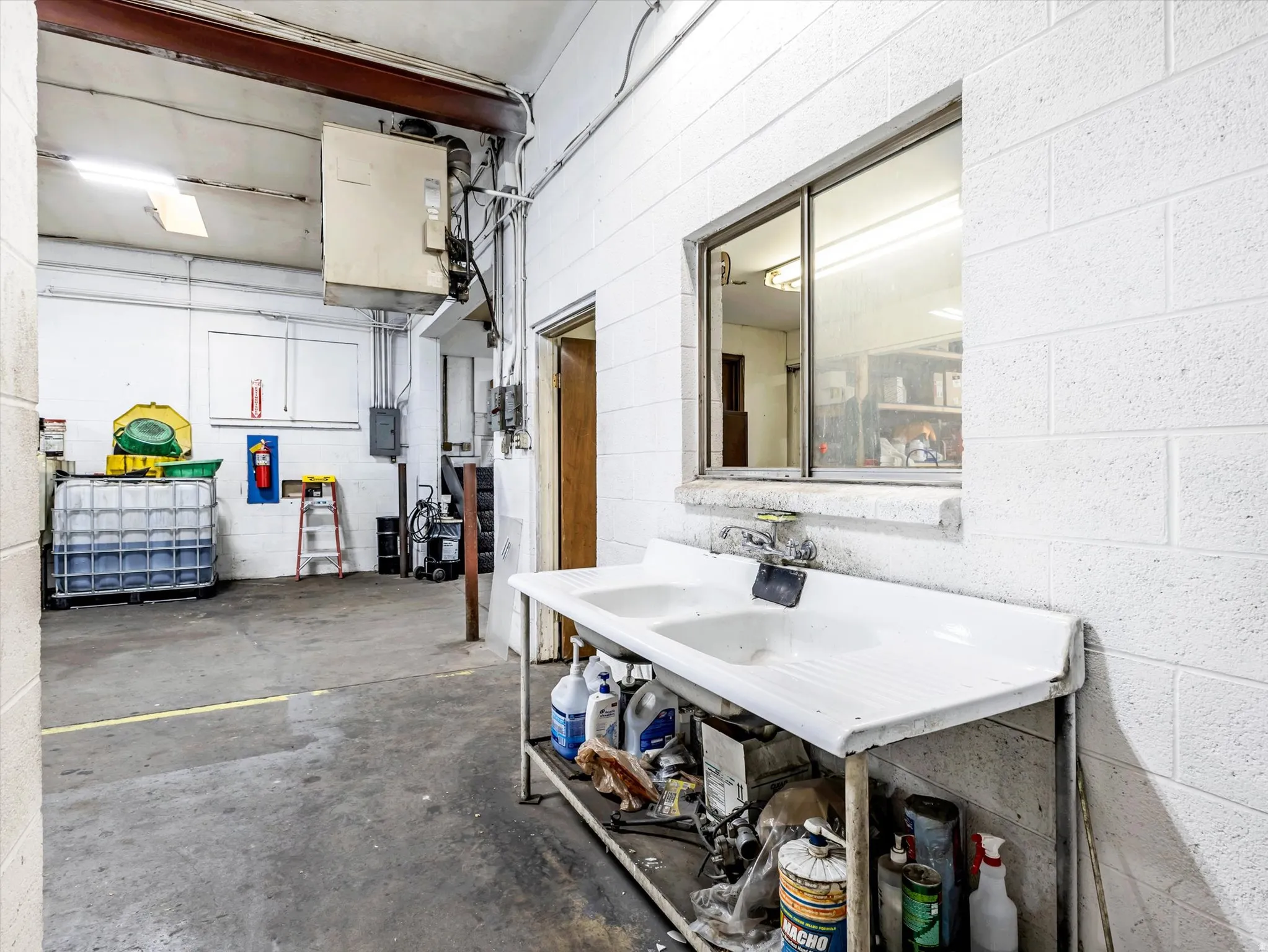 Garage with concrete block wall and a heating unit
