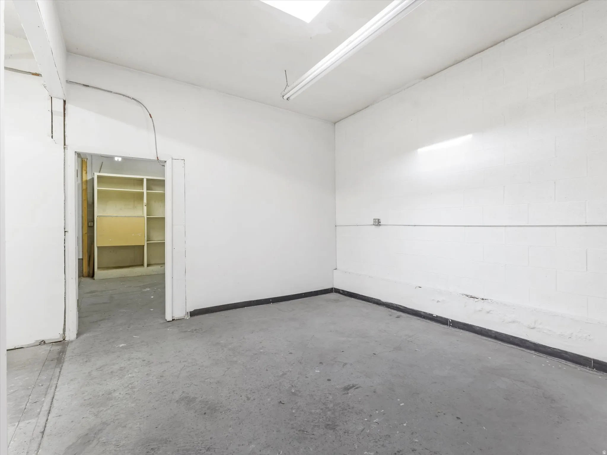 Empty room with unfinished concrete floors