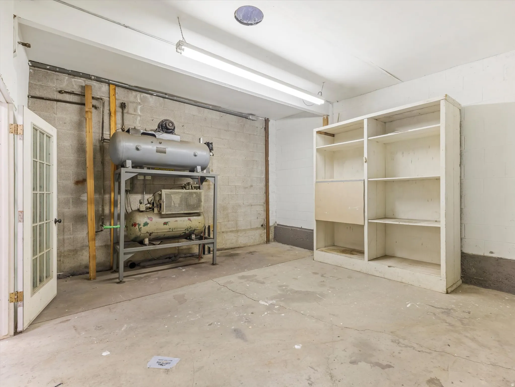 Below grade area featuring concrete block wall