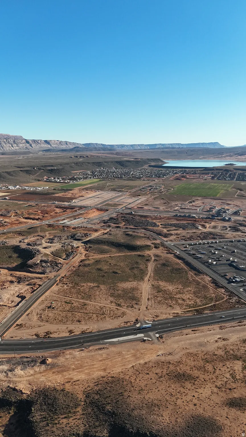 Aerial view of sparsely populated area with a desert landscape and a mountain backdrop