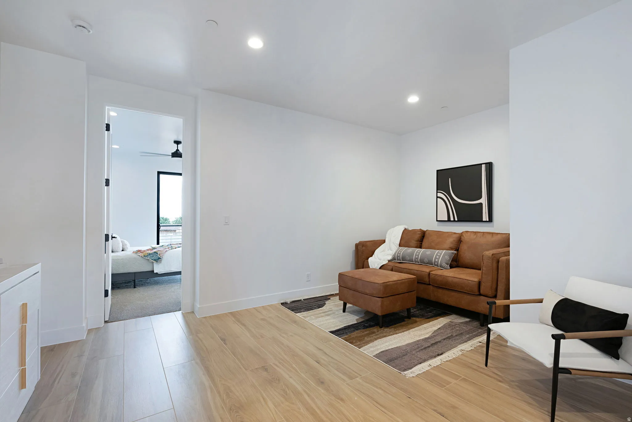 Living area featuring light wood-style flooring, recessed lighting, and ceiling fan