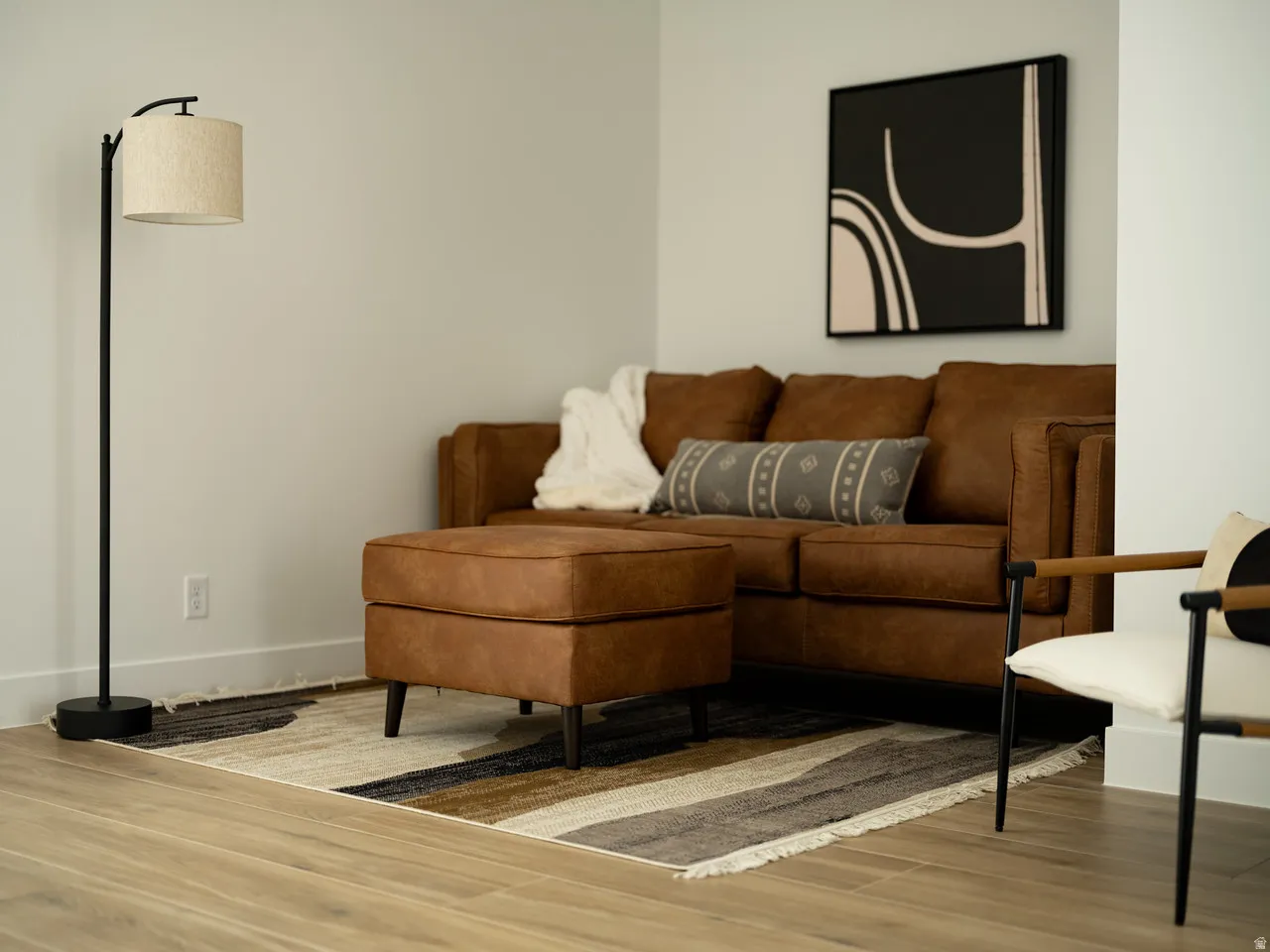 Living area with wood finished floors and baseboards