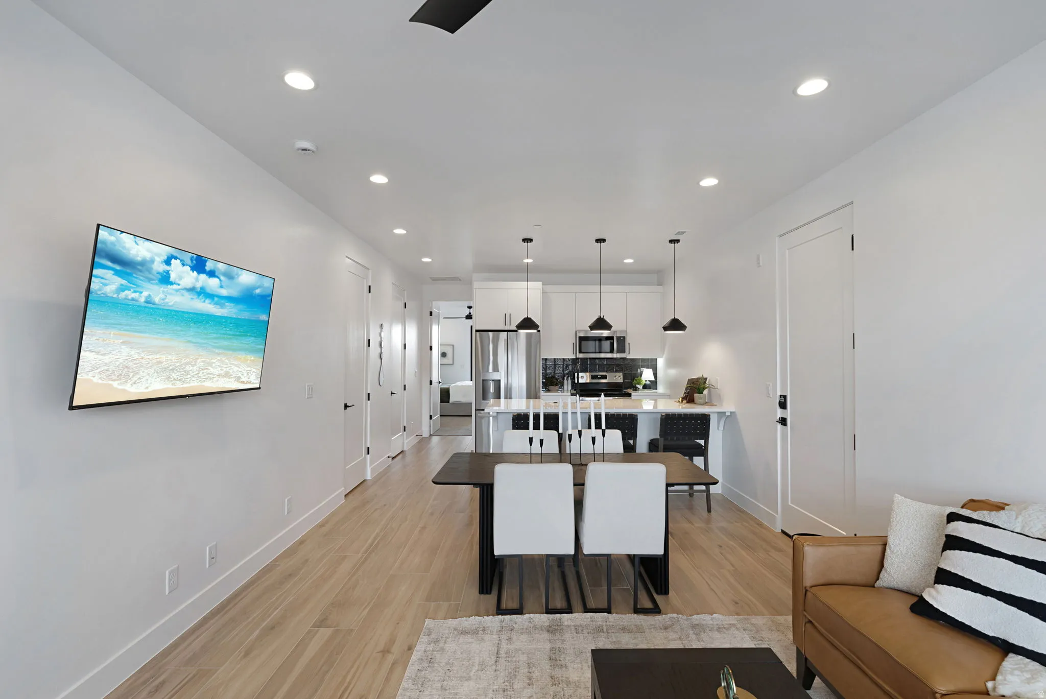 Living room with recessed lighting and light wood-style floors