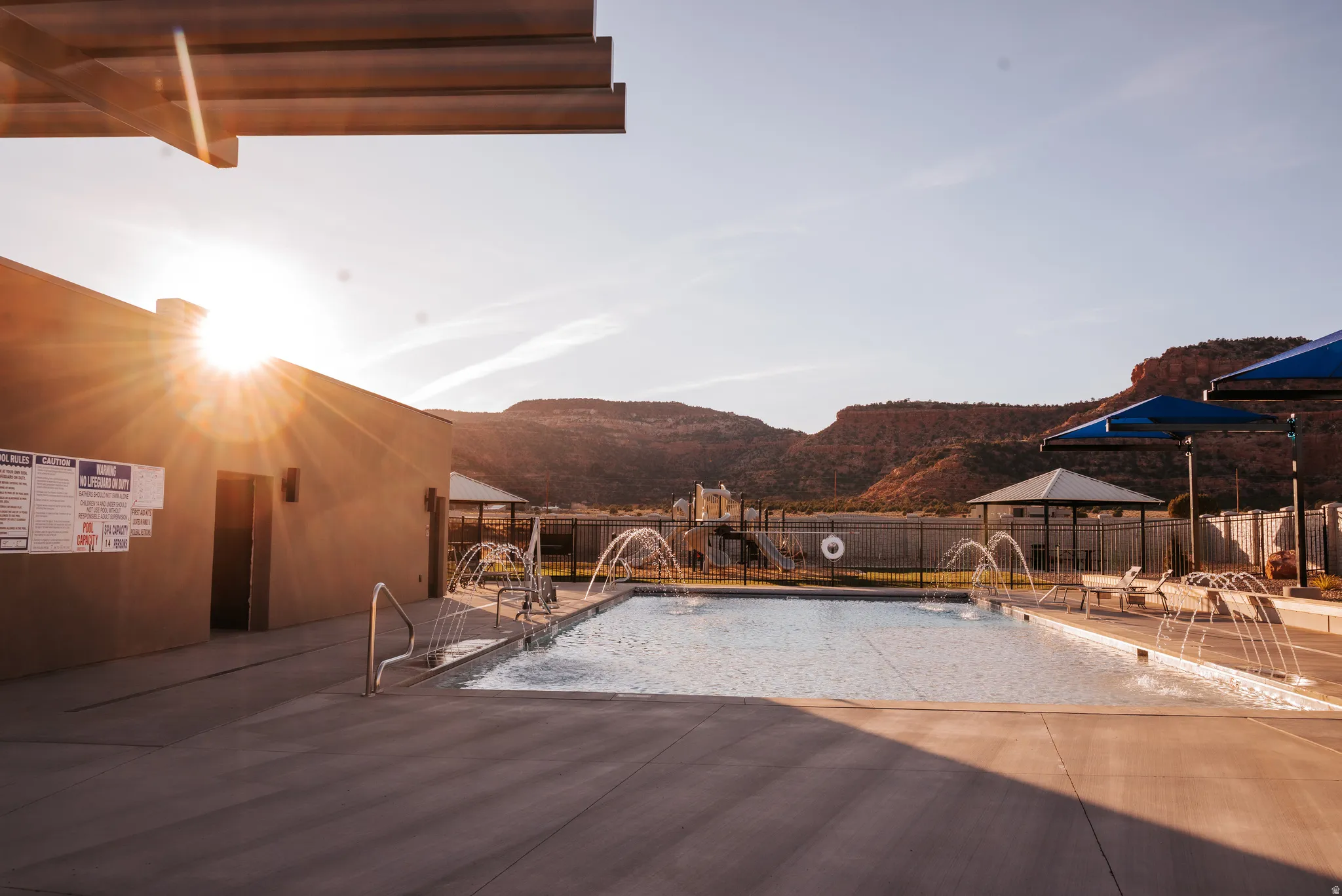 Community pool with a fenced backyard, a patio area, a gazebo, and a mountain view