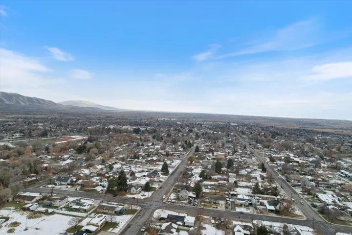 Aerial view of property's location featuring nearby suburban area and a mountainous background