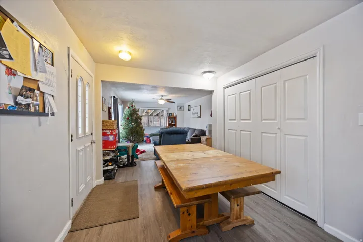 Dining room with wood finished floors, ceiling fan, and a textured ceiling