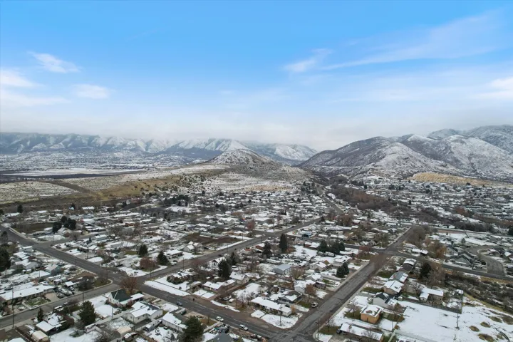 Snowy aerial view with a residential view and a mountain view