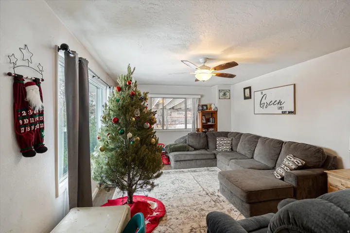 Living room featuring a textured ceiling and ceiling fan