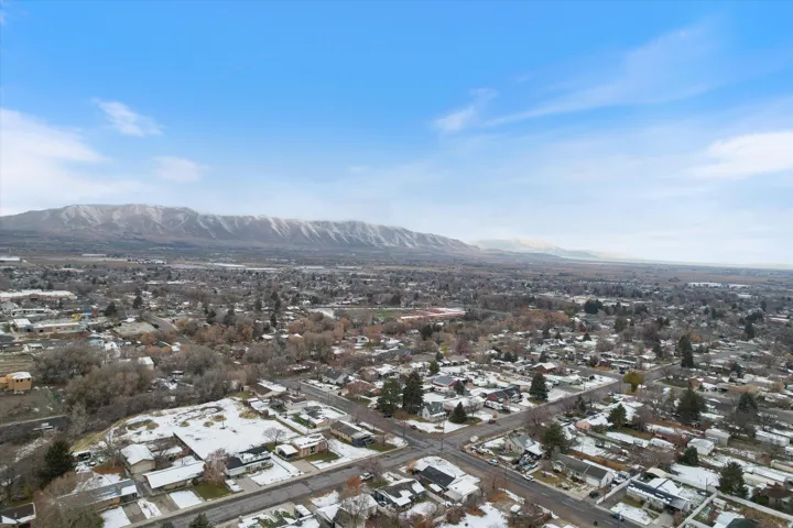 Aerial overview of property's location featuring mountains and nearby suburban area