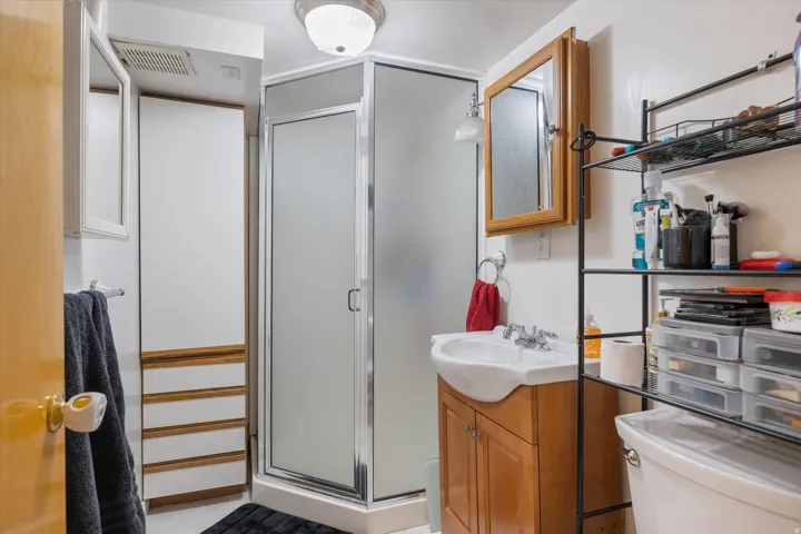 Bathroom with vanity and a stall shower
