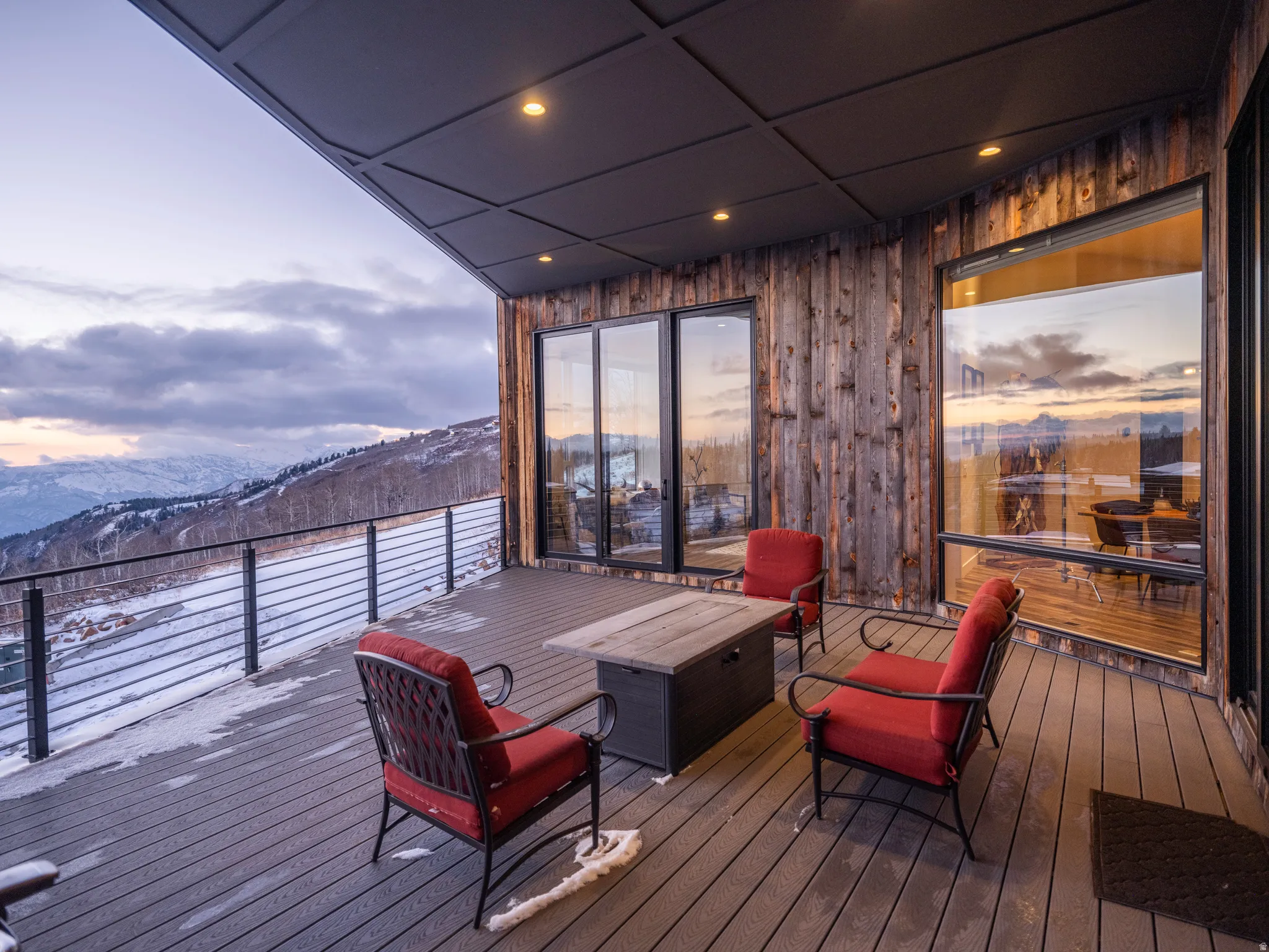 Snow covered deck featuring a mountain view