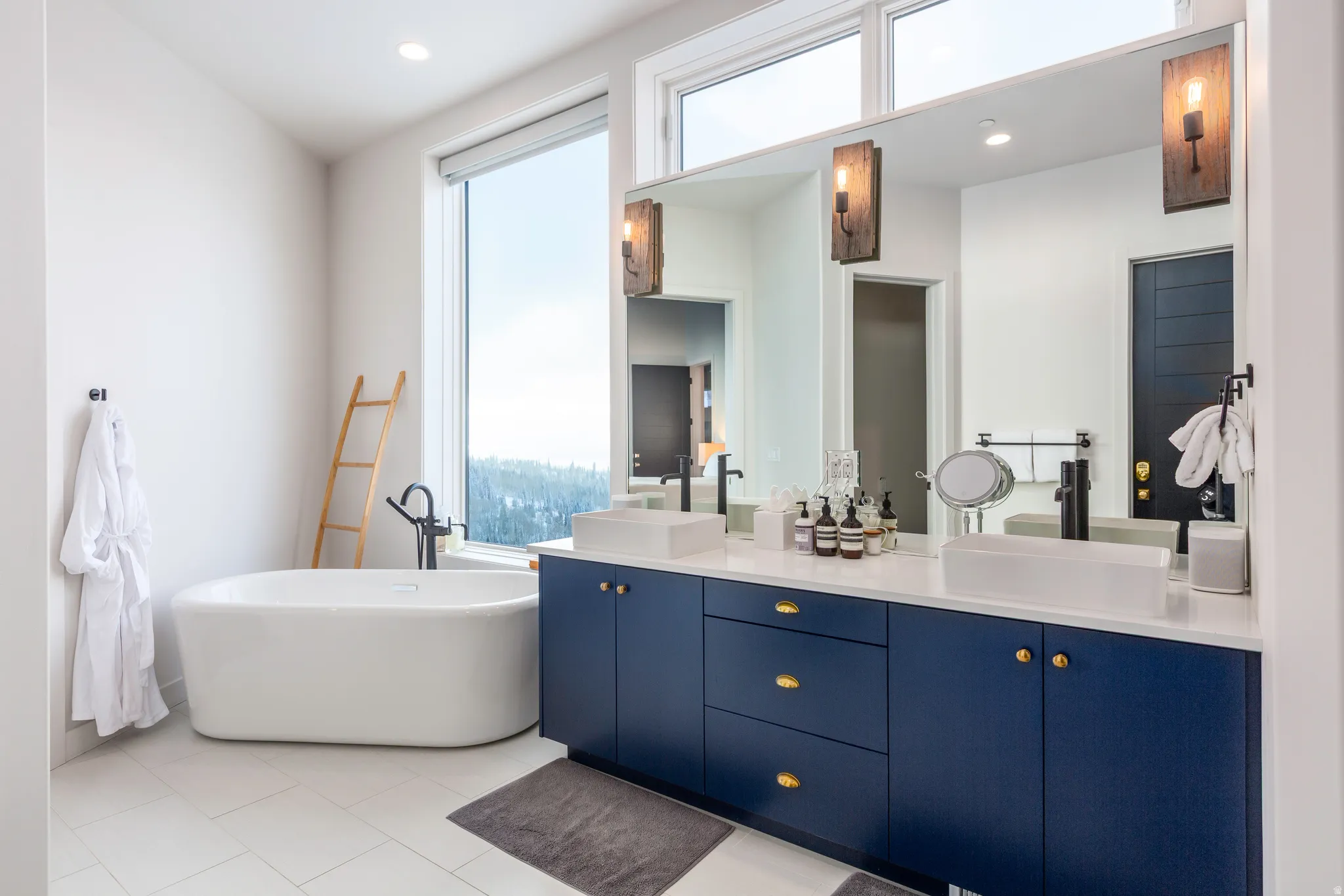 Bathroom with double vanity, a soaking tub, recessed lighting, and light tile patterned flooring