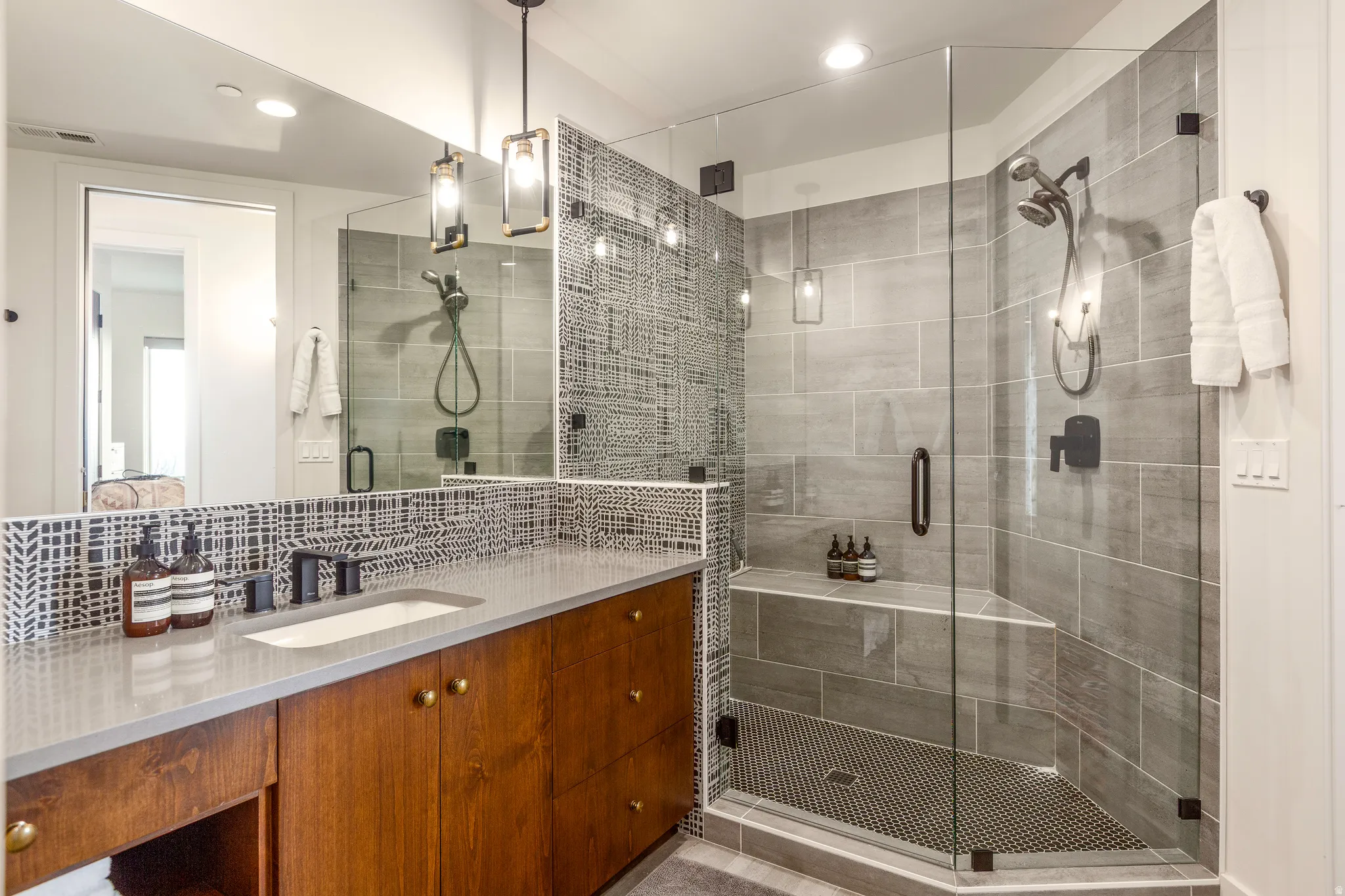 Full bath with vanity, a shower stall, recessed lighting, and decorative backsplash