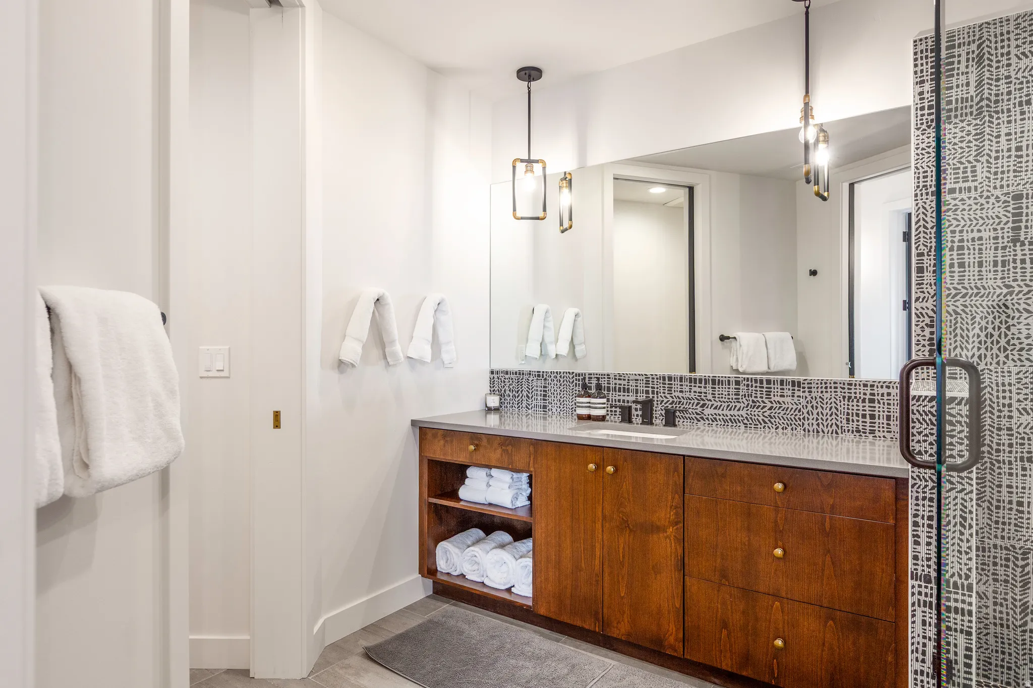 Full bathroom with vanity, tasteful backsplash, and a shower stall