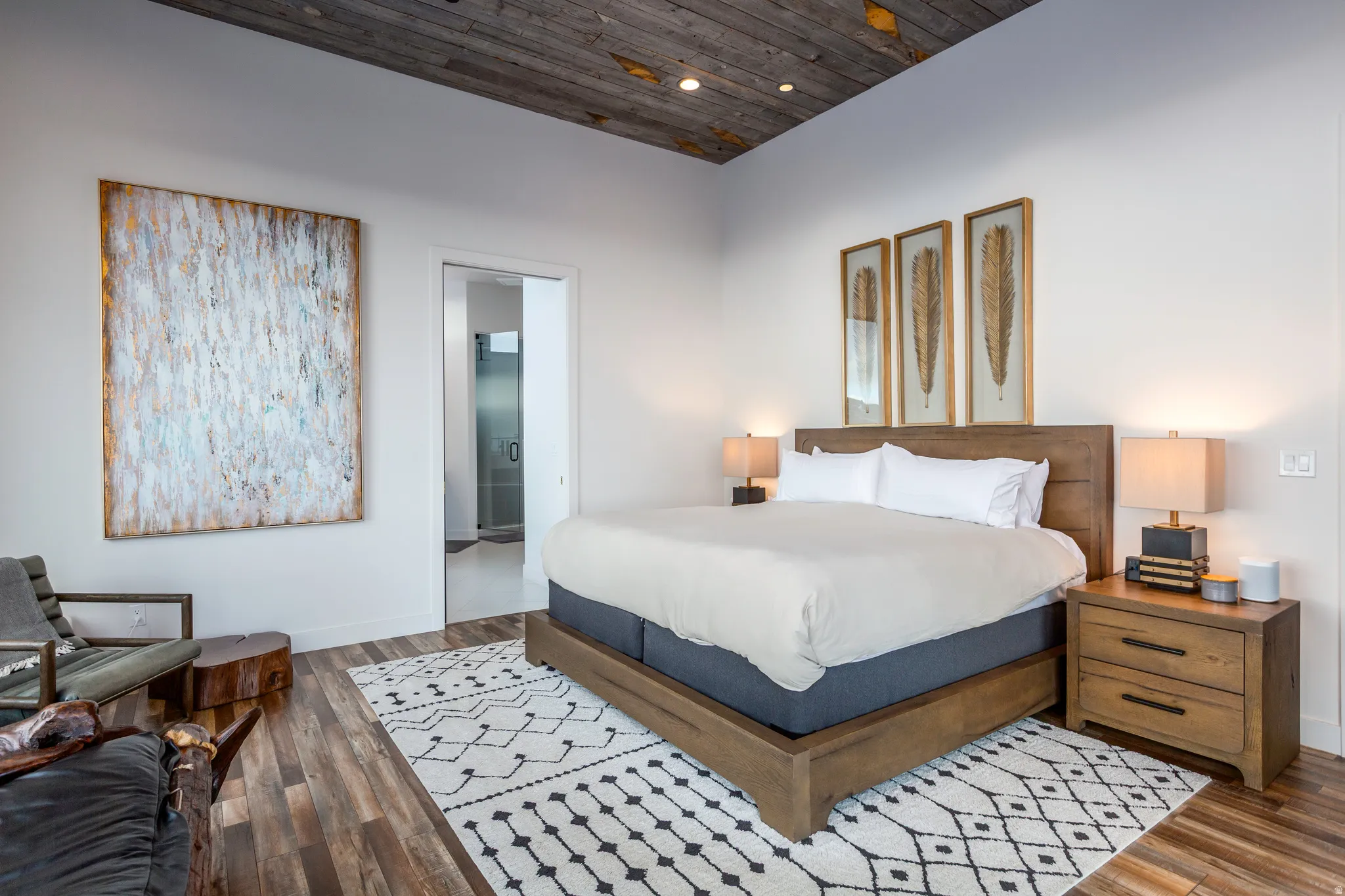 Bedroom with wooden ceiling, connected bathroom, dark wood-type flooring, and recessed lighting