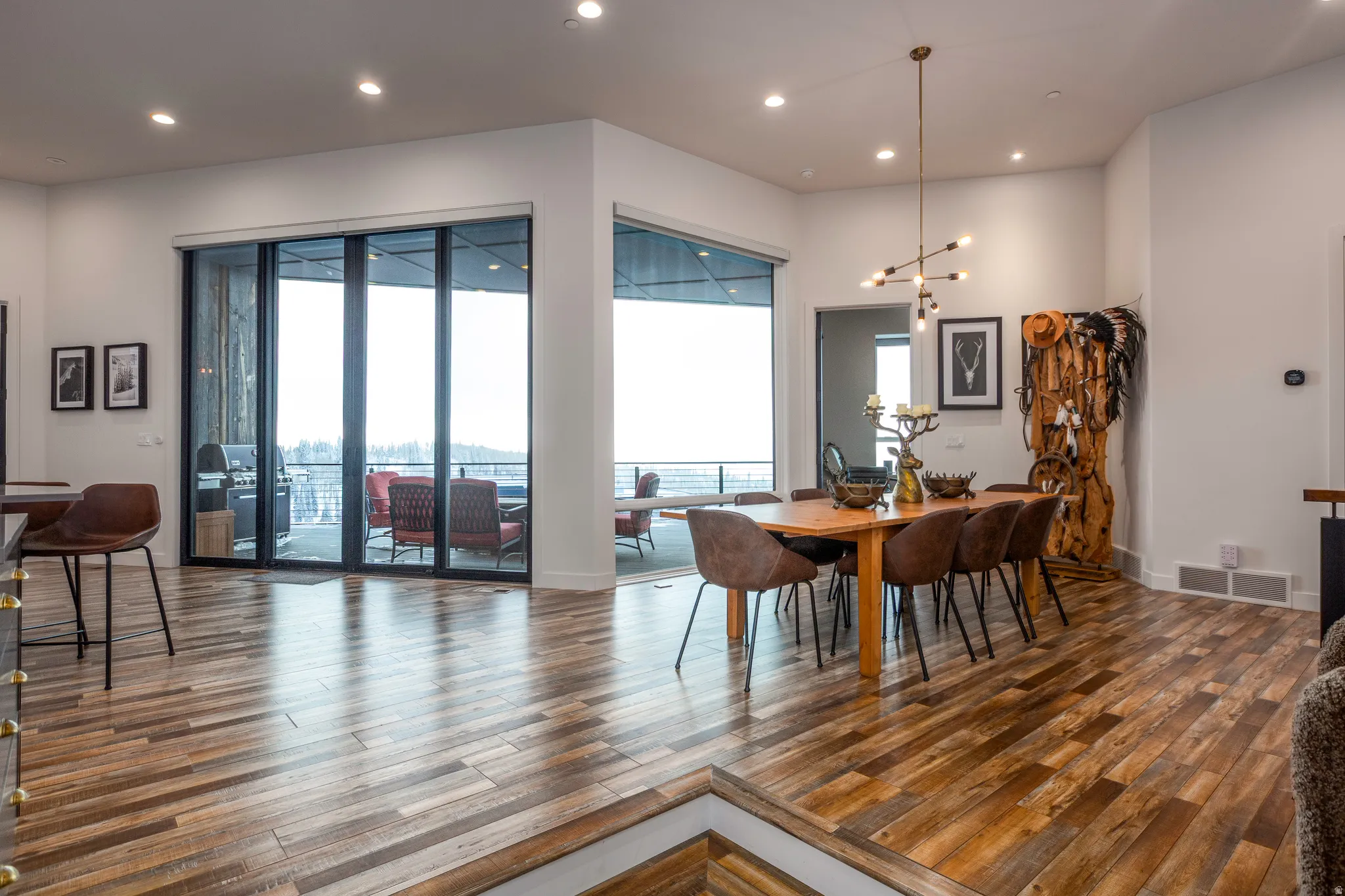 Dining area with recessed lighting, dark wood-style floors, healthy amount of natural light, and a chandelier
