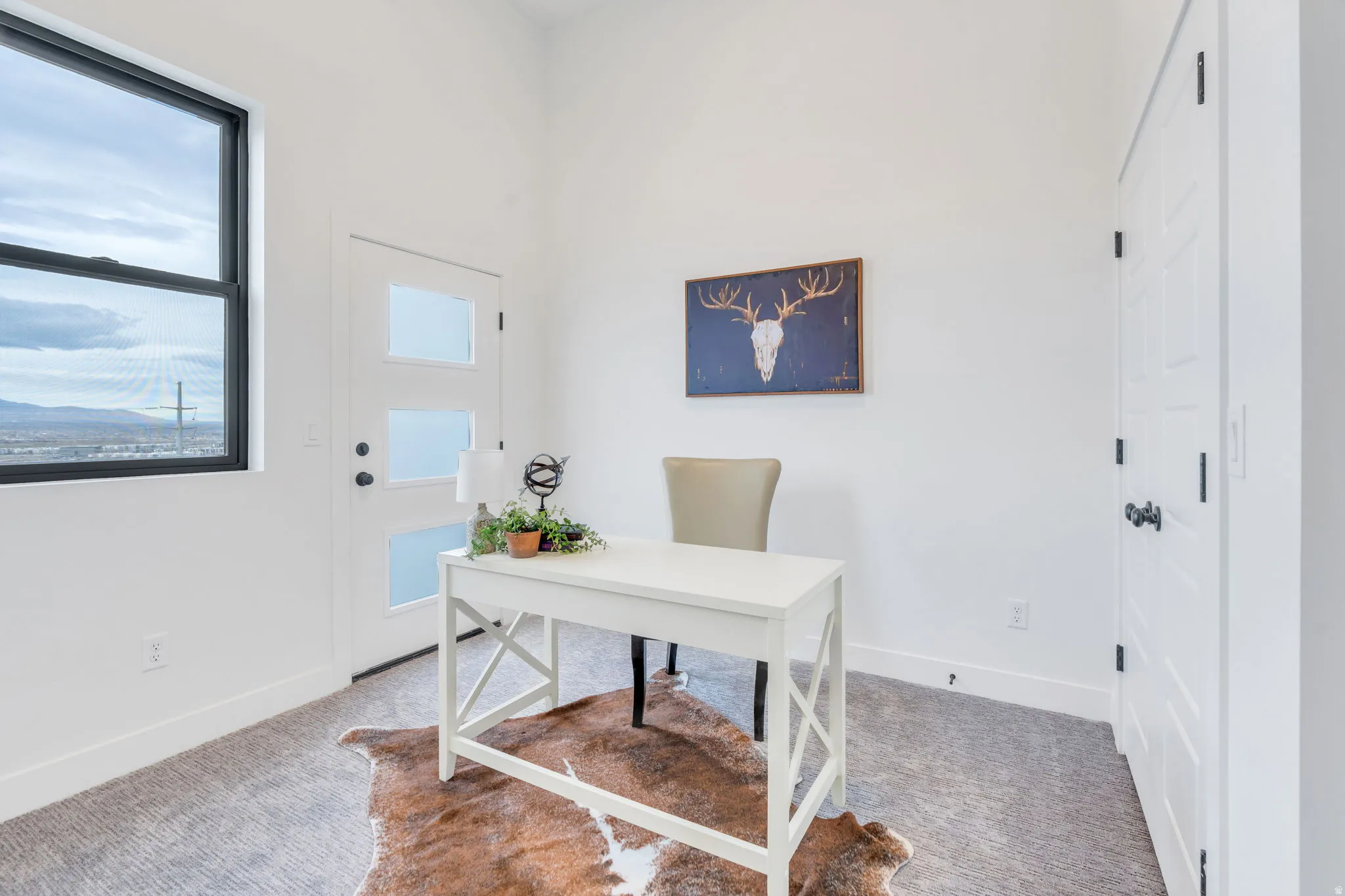 Carpeted home office with baseboards